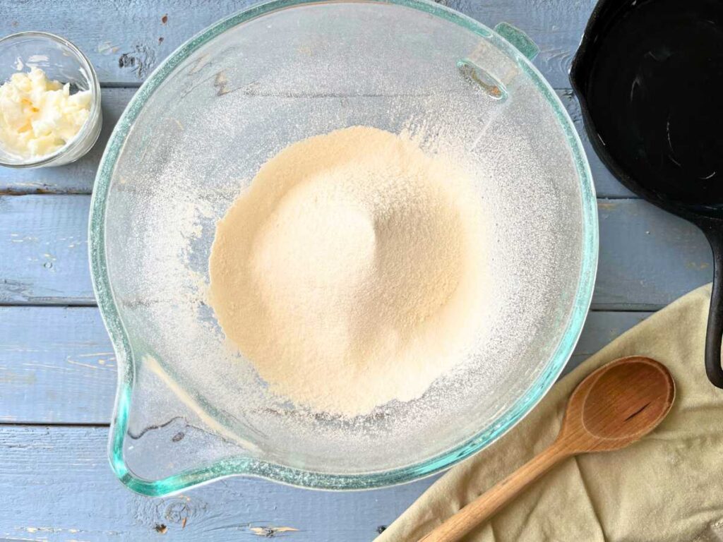 A glass bowl full of sifted flour.