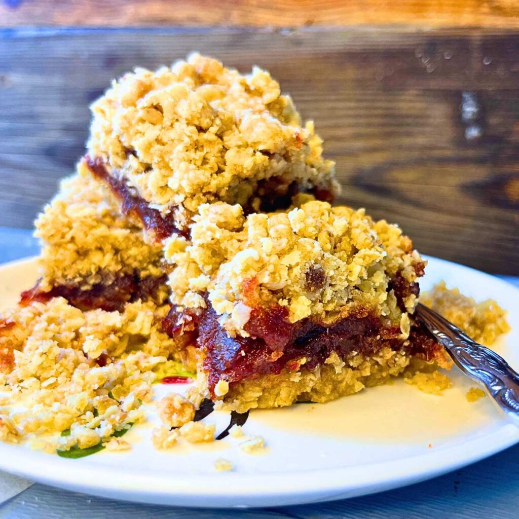 Three date squares on a white plate.