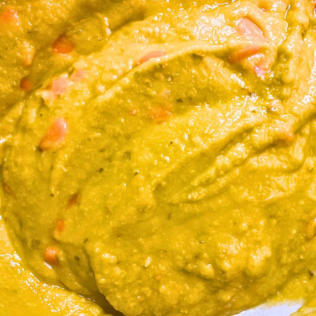 A close up look at a pot of split-pea soup.