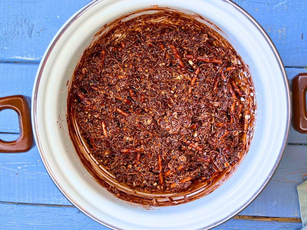 A chocolate mixture in a white sauce pot.