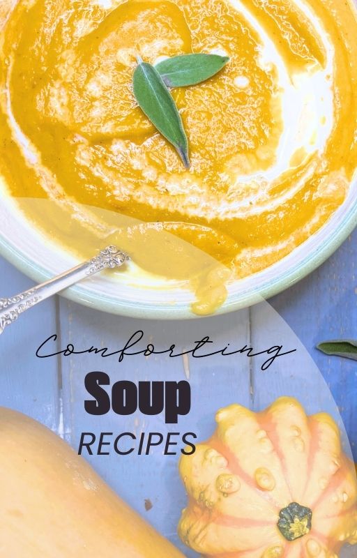 A bowl of butternut squash soup with a swirl of cream. There are sage leaves on top of the soup.