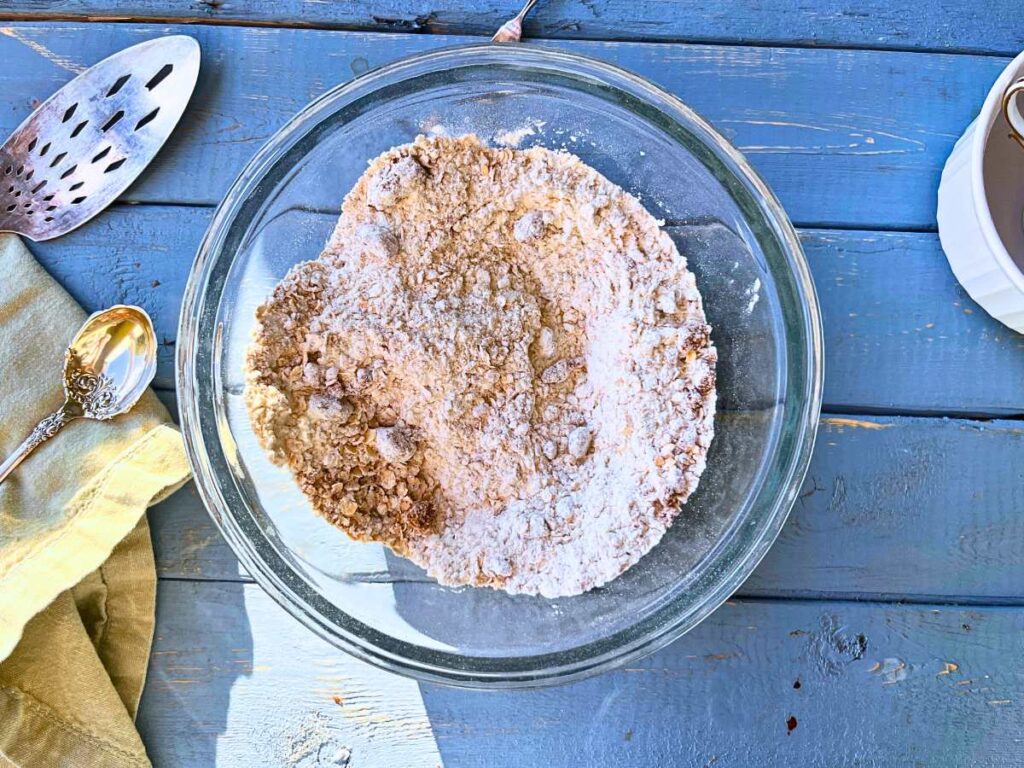 A glass bowl with dry ingredients inside.