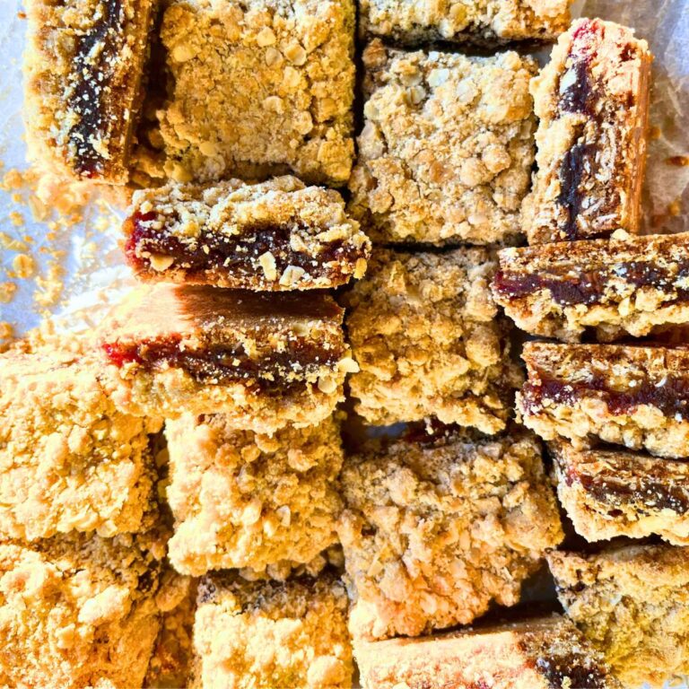 Date squares on a piece of parchment paper. Some are on their sides.