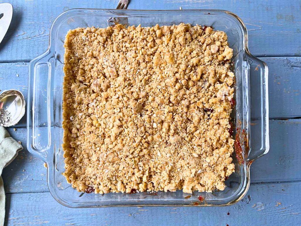 Unbaked date squares in a square glass casserole dish.