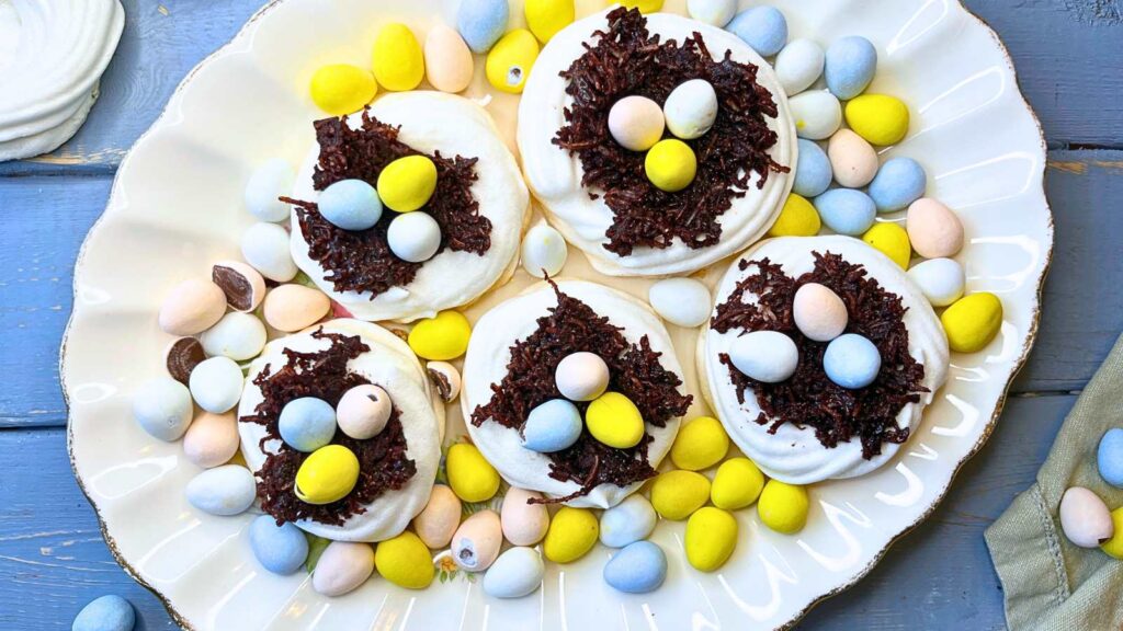 A ground of meringue nests filled with chocolate and candy eggs.