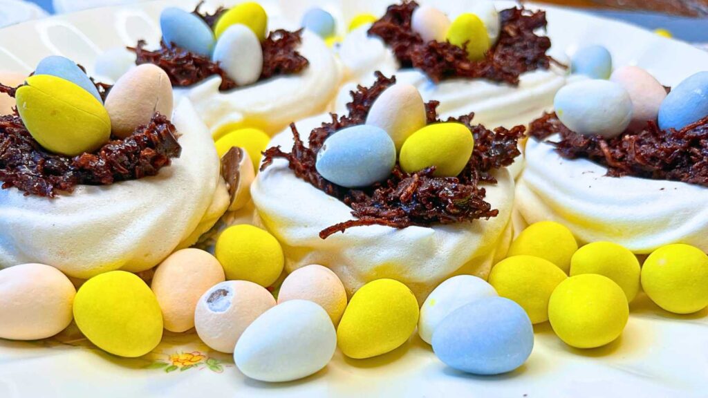 A ground of meringue nests filled with chocolate and candy eggs.