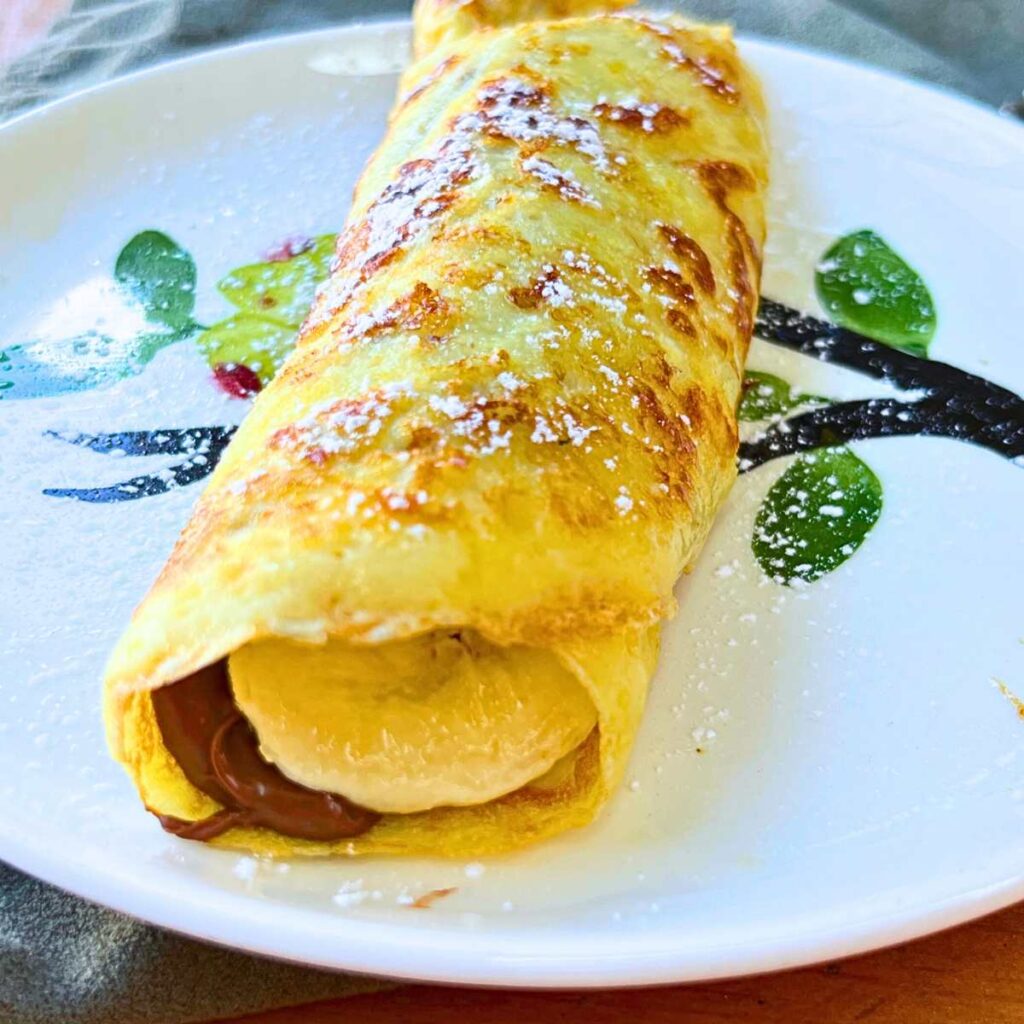 A crêpe filled with Nutella and sliced banana.