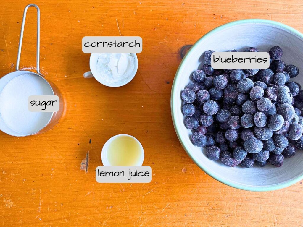 A wooden table with labeled ingredients.