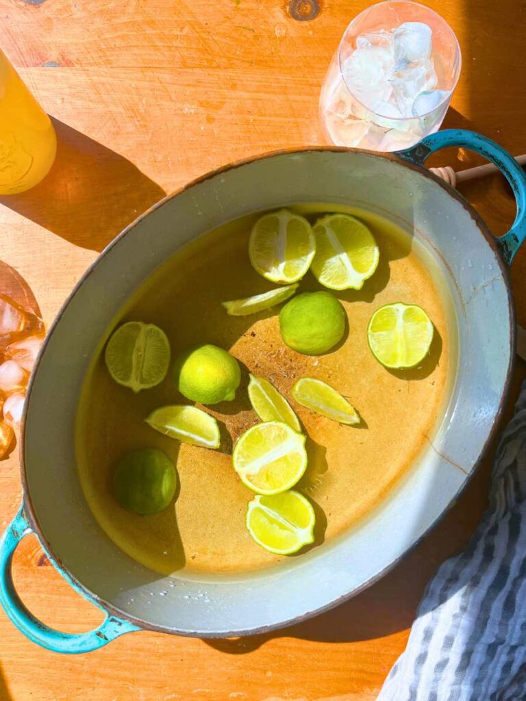 Sliced limes and water in a large pot.