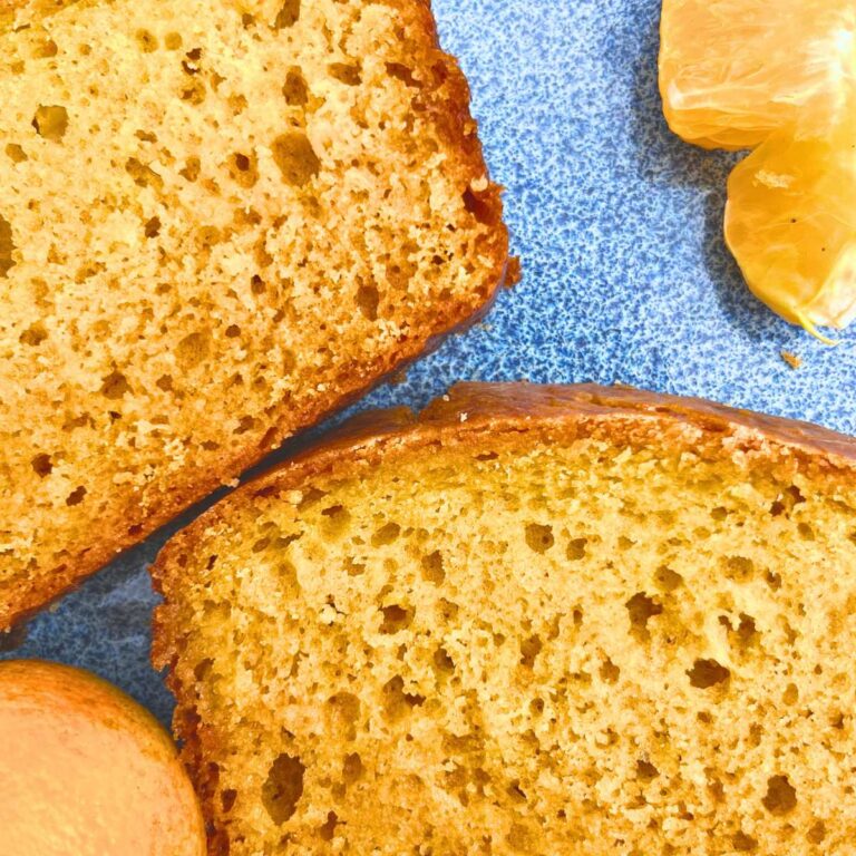 A close up look at two slices of orange loaf cake.
