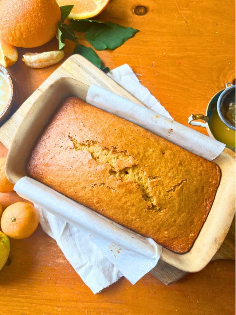 A baked orange loaf in a stone loaf pan.