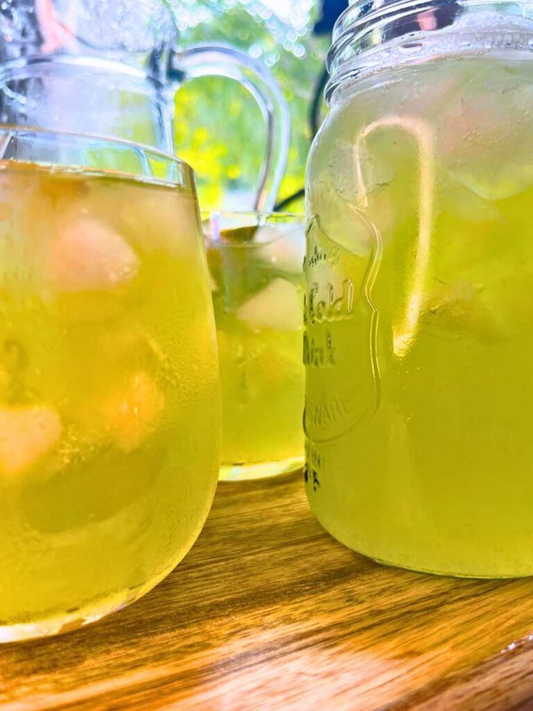 A close up look at two glasses of limeade with ice inside.