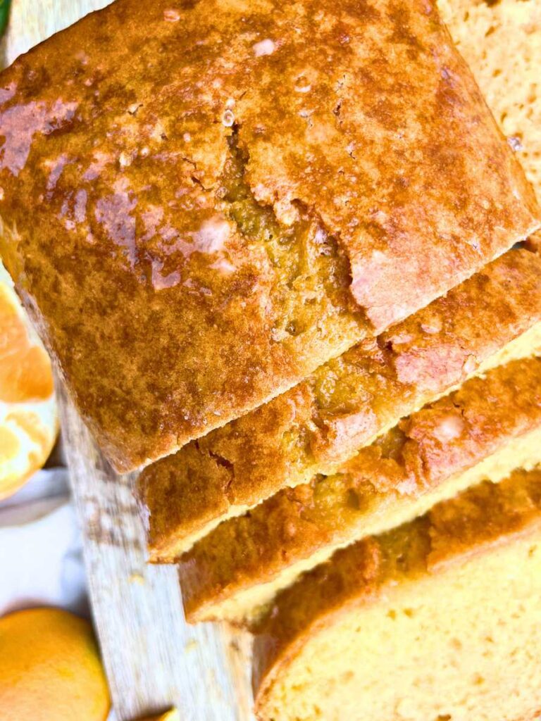 An over head view of a partially sliced orange bread loaf.