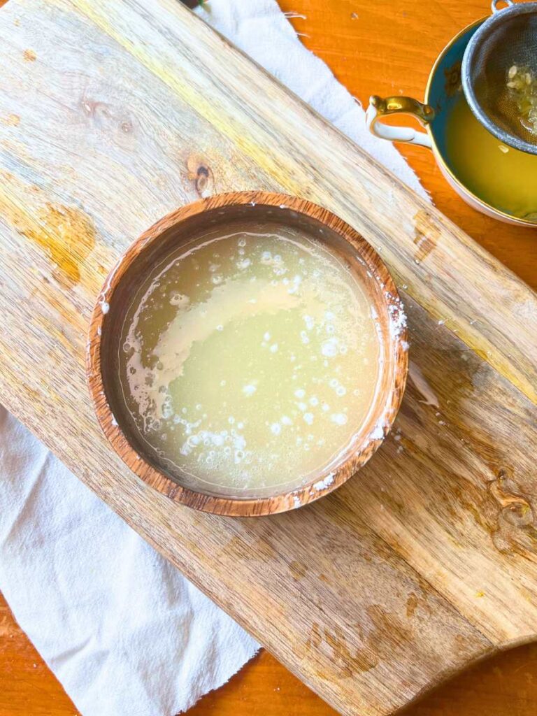 A small wooden bowl with a glaze inside.