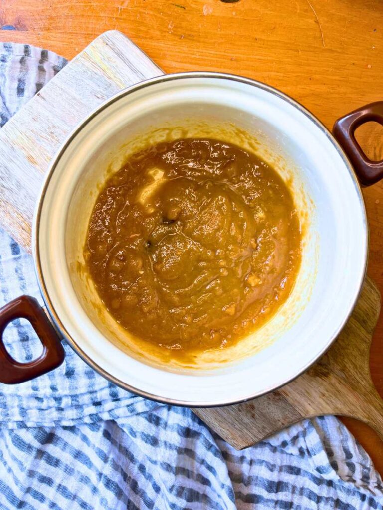 A sugar and butter mixture in a white sauce pot.