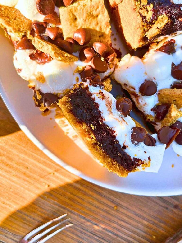 A white plate full of s'mores themed bars.