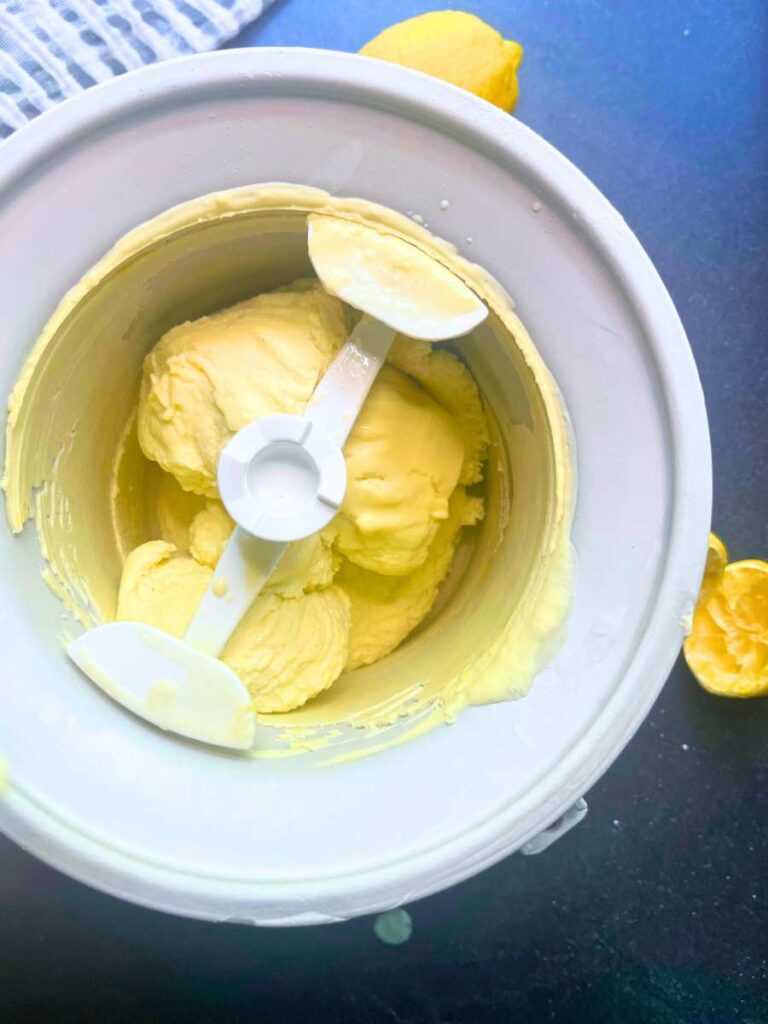 An ice cream maker with lemon gelato inside.