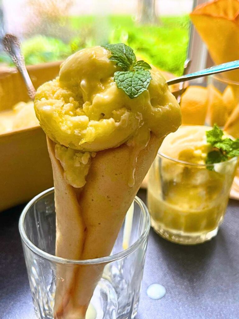 A homemade ice cream cone with lemon gelato inside.