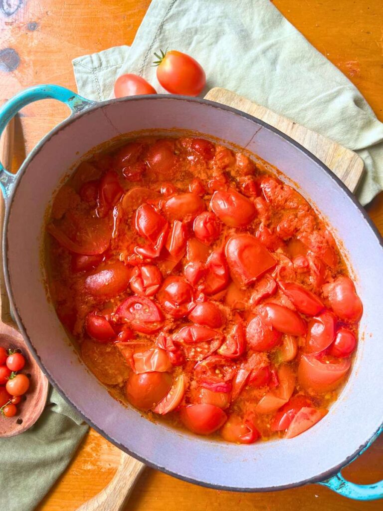 Cooked tomatoes in a large Dutch oven.