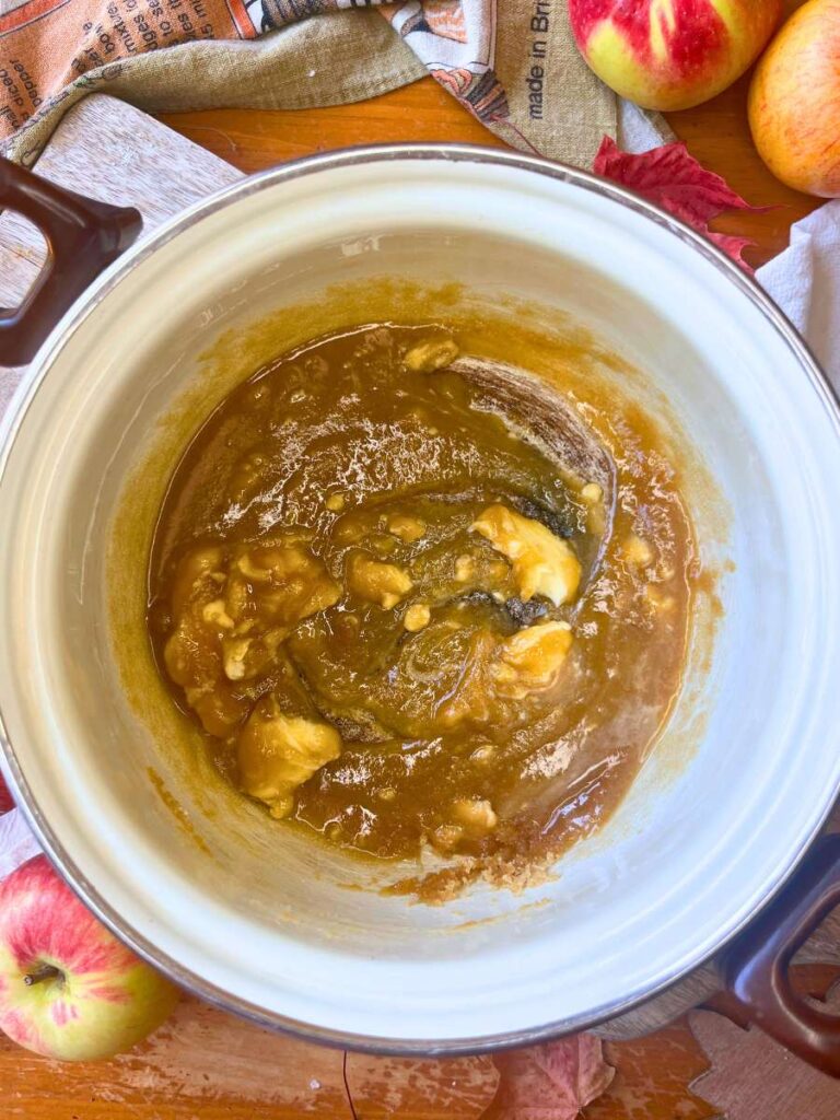 A white sauce pot with melted butter and brown sugar.