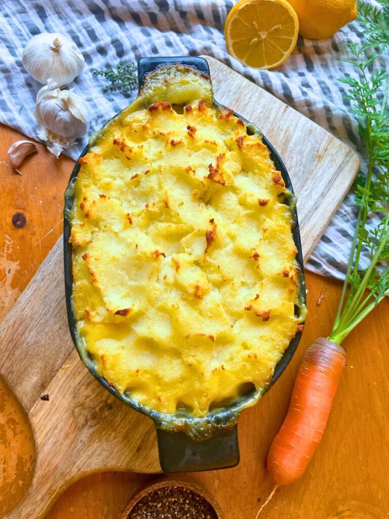 A baked shepherd's pie in a black casserole dish.