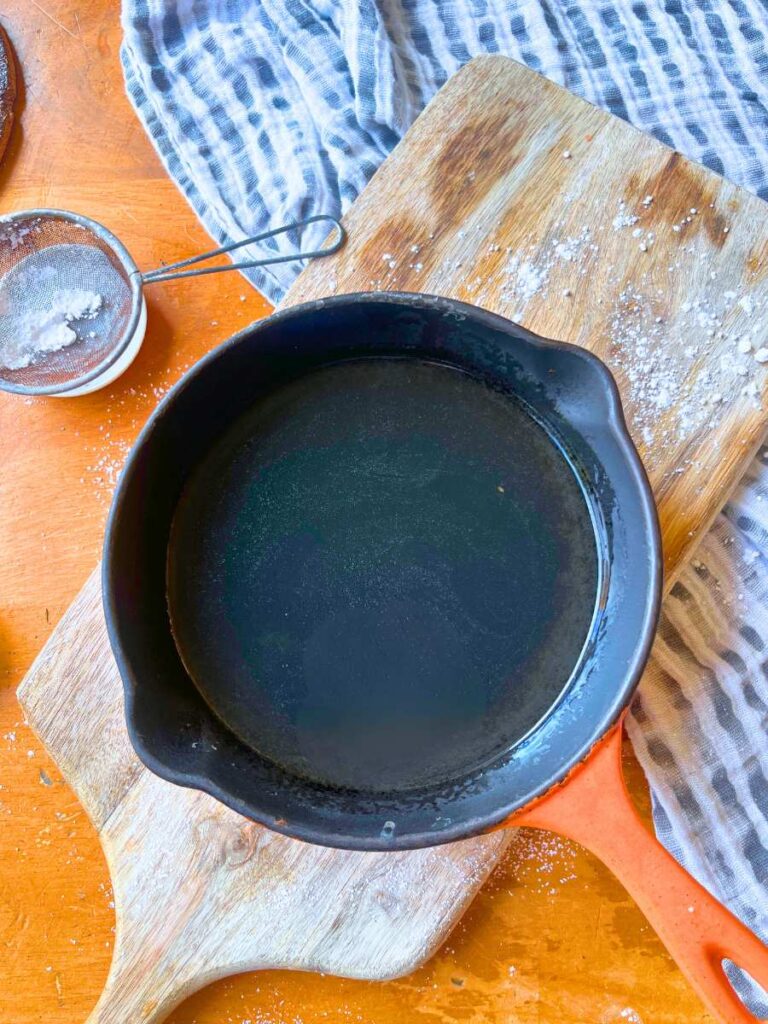 Gelatine and water dissolved in a black and orange pan.