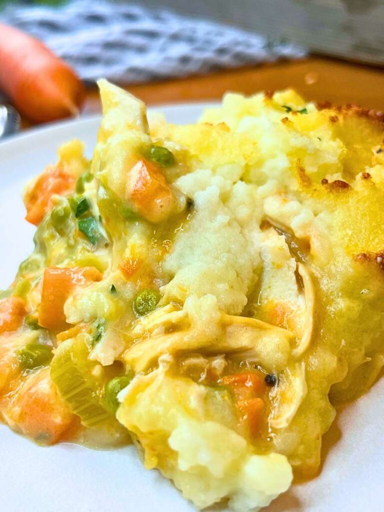 A serving of turkey shepherd's pie on a white plate.