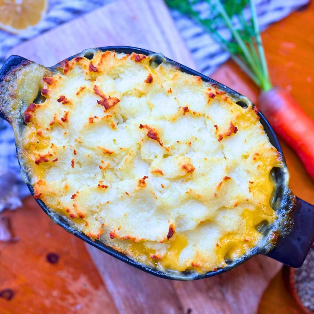 A shepherd's pie in a black casserole dish.