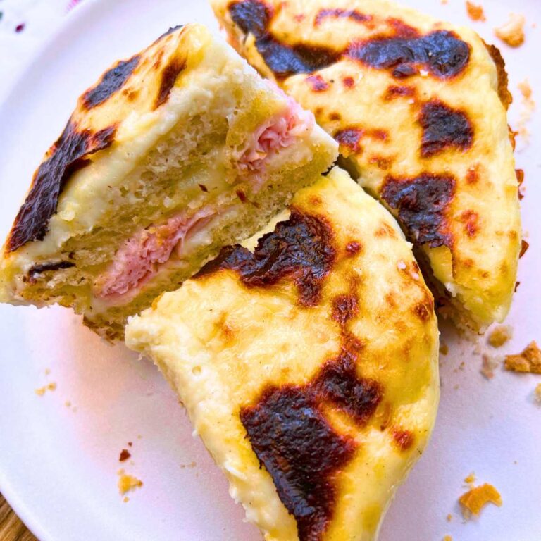 A croque monsieur sandwich sliced in three.