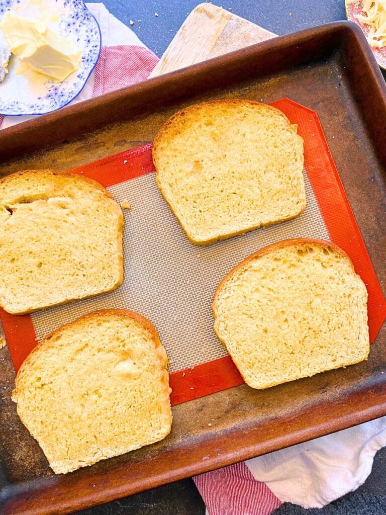 A baking sheet with 4 slices of toast.