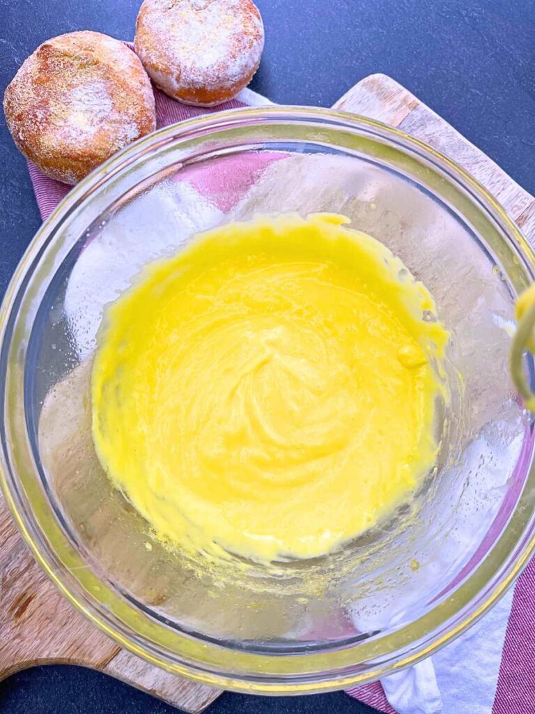 A finished hollandaise sauce in a glass bowl.