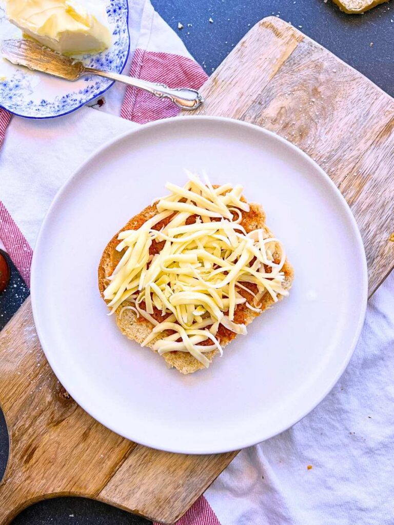 A piece of bread with grated cheese.