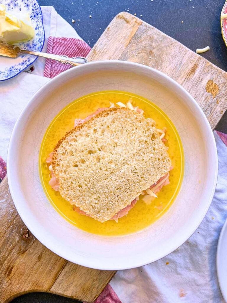 A ham and cheese sandwich in an egg batter.