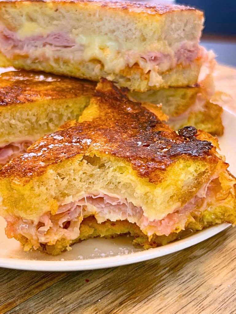 A sliced sandwich with a bite out of it.