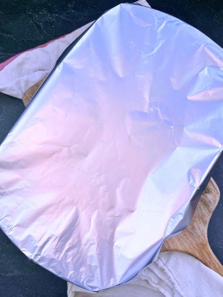 A casserole dish covered in foil.