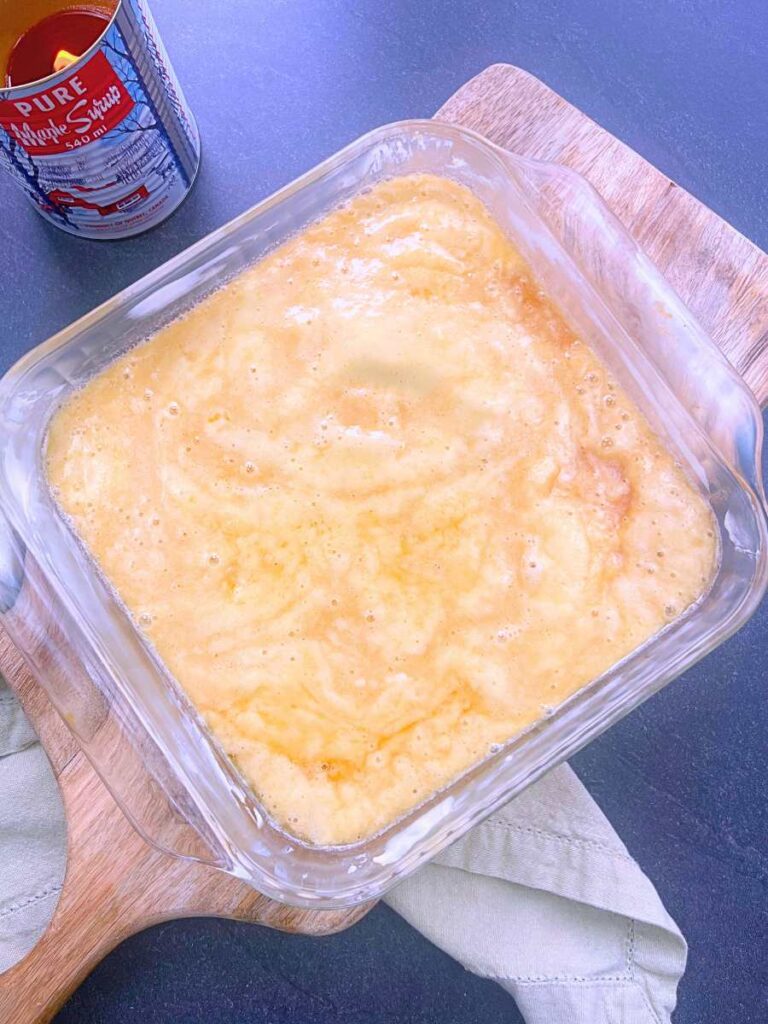 Pouding chômeur batter in a square casserole dish.