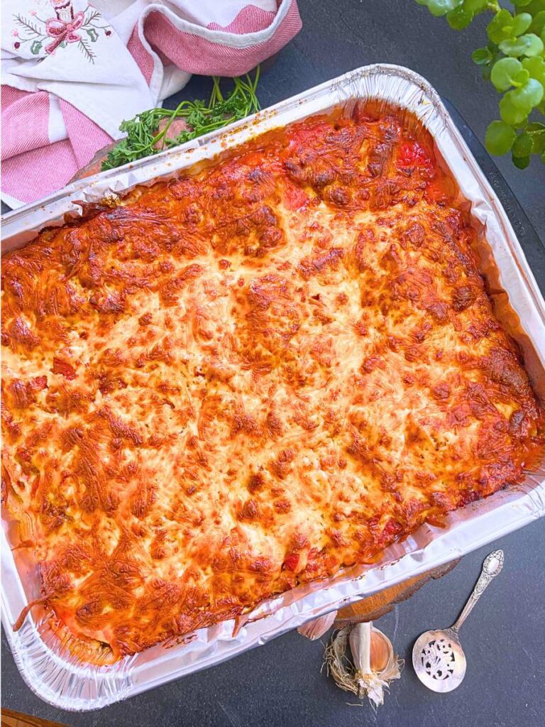 A baked freezer lasagna in an aluminum pan.
