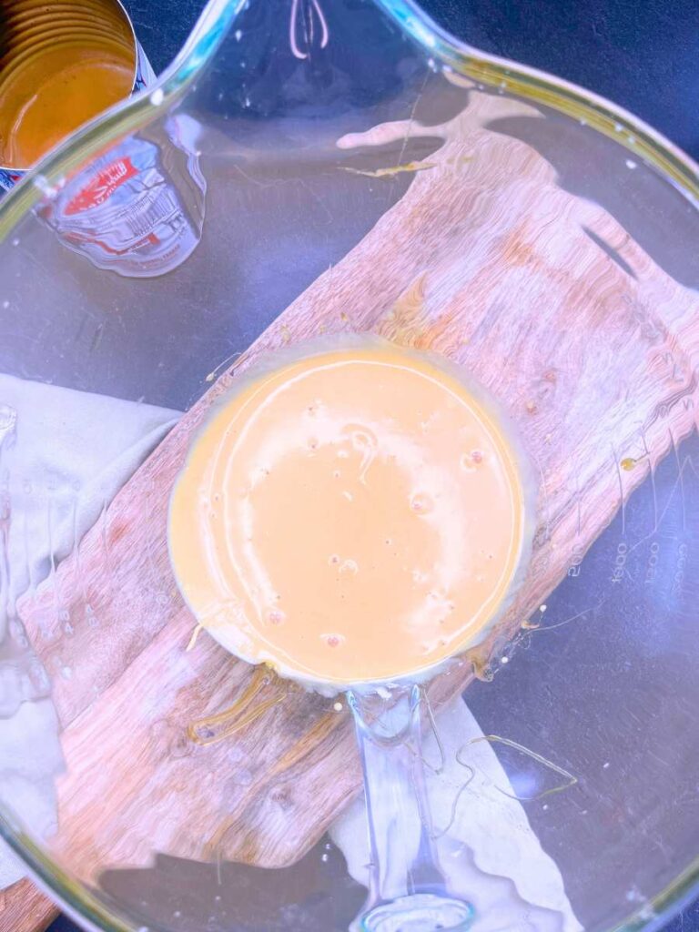 A glass bowl with creamed, cooked maple syrup.