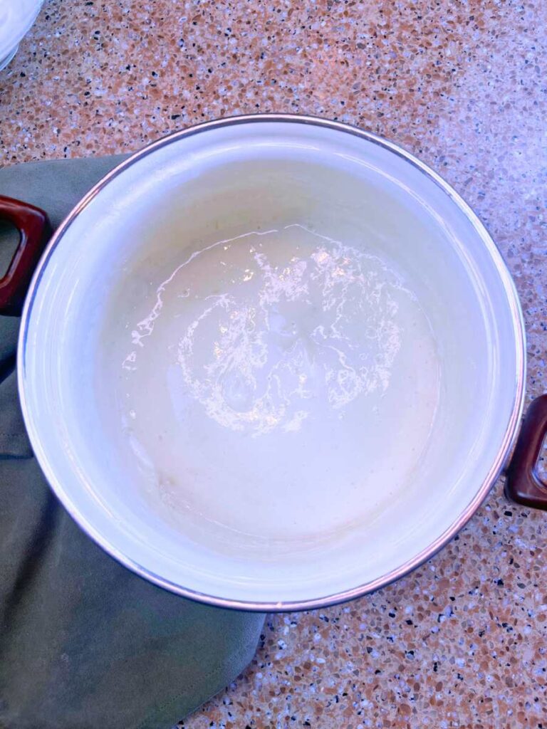 Melted marshmallows in a white sauce pot.