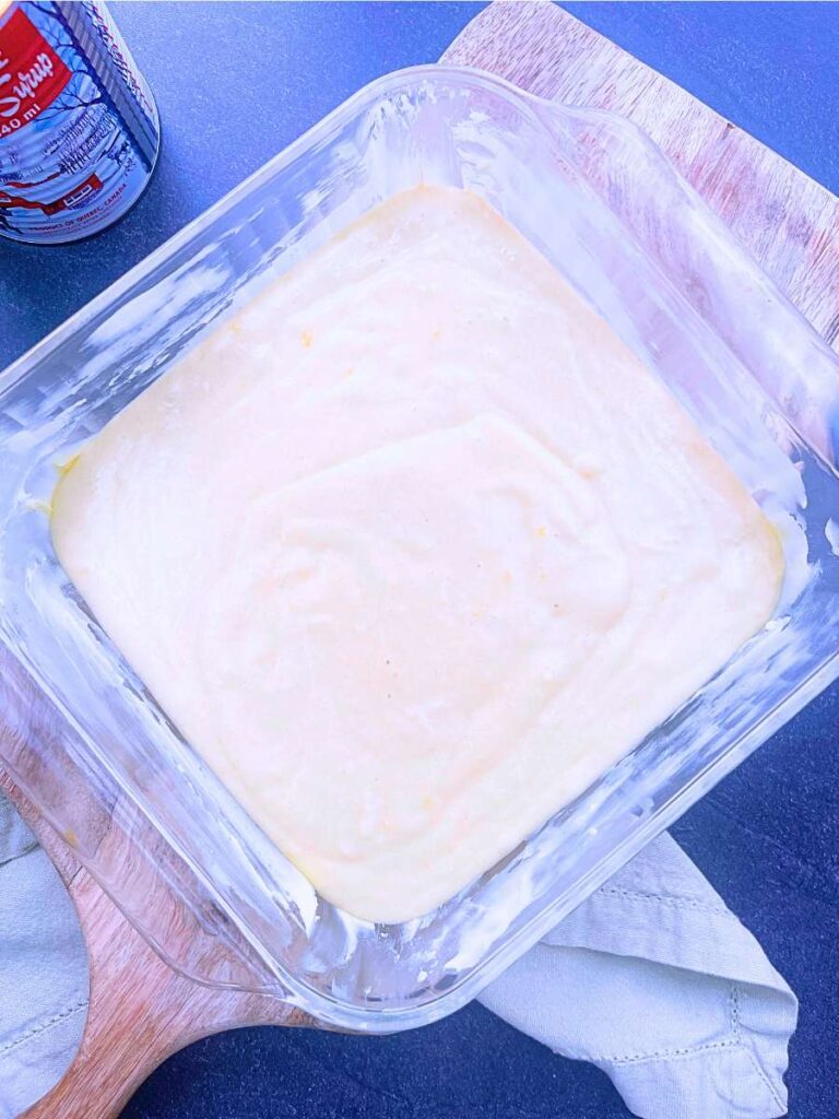 Cake batter in a square casserole dish.