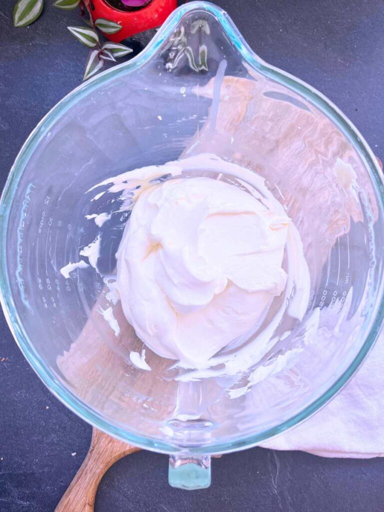 White chocolate whipped cream, whipped in a glass bowl.