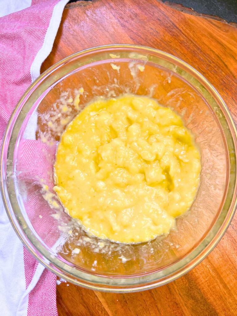 Mashed bananas in a glass bowl.
