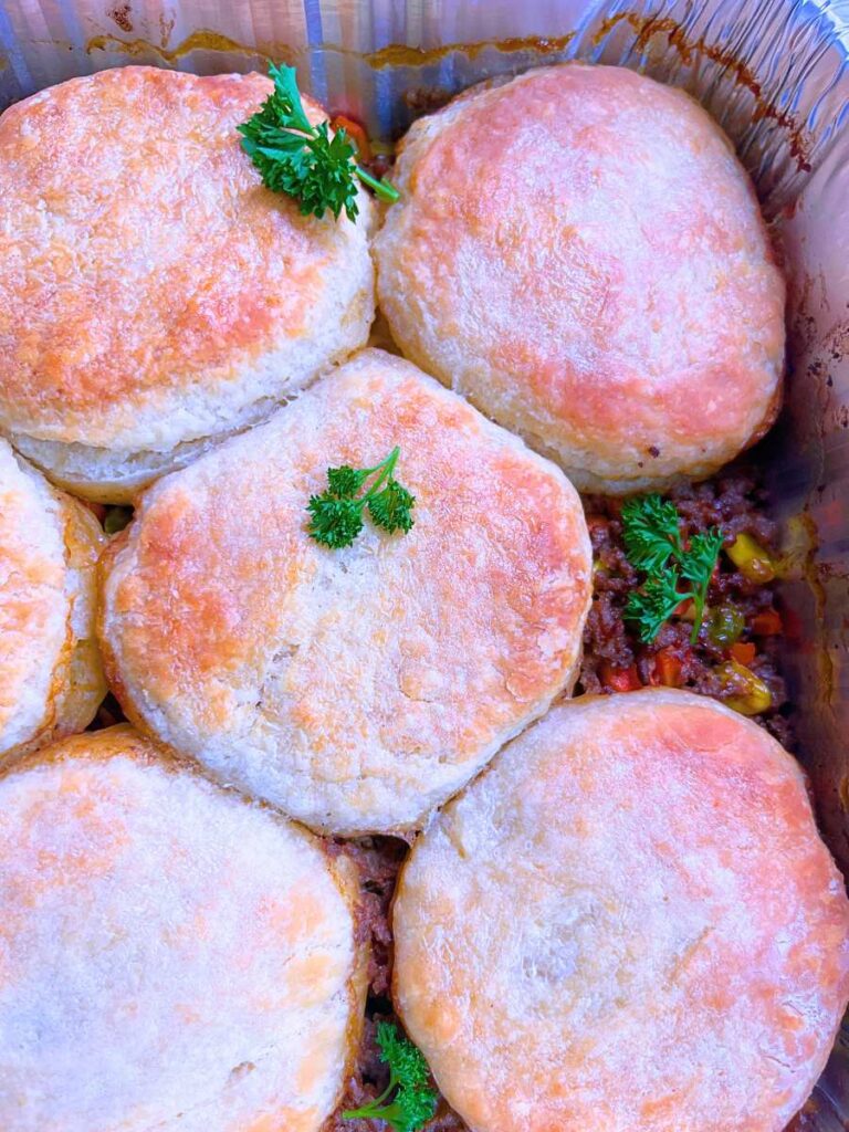 An over head view of a baked biscuit topped ground beef pot pie.
