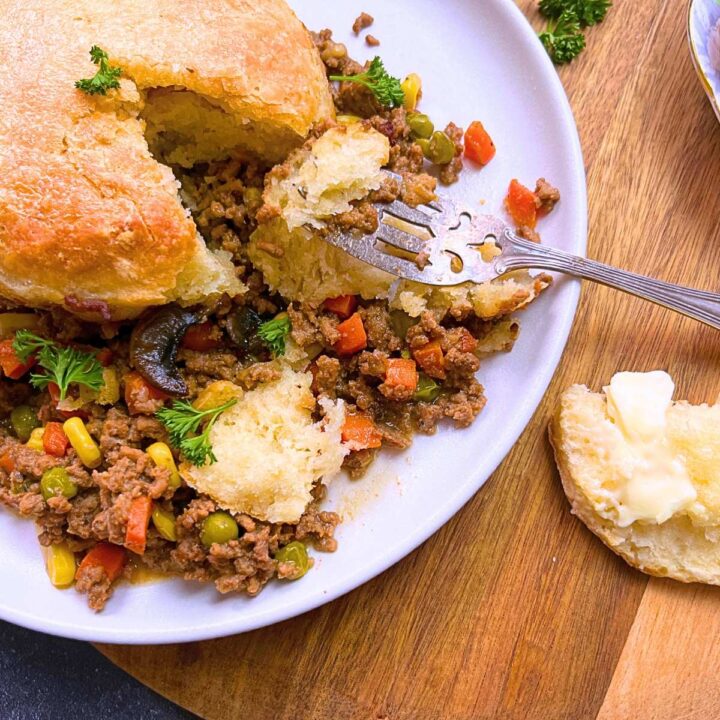 A serving of ground beef pot pie with a fork inside.