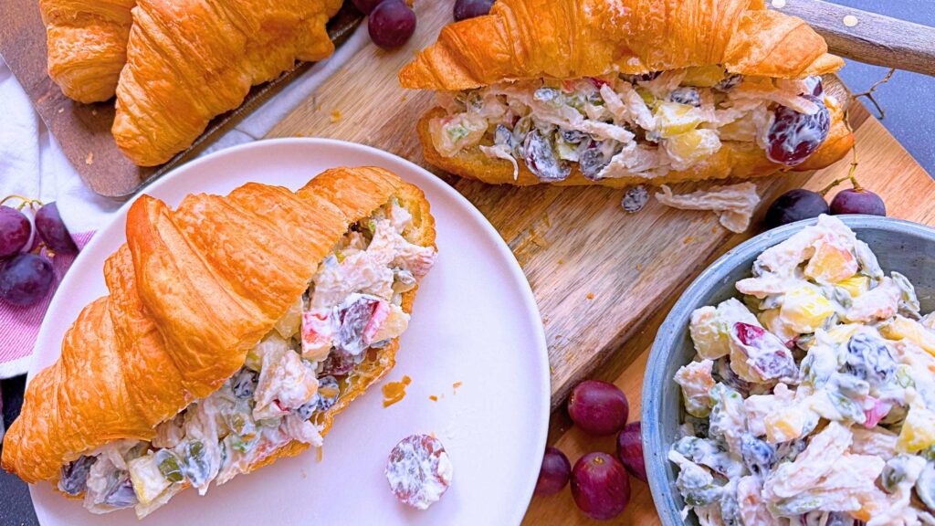 Two croissants filled with Waldorf chicken salad filling.