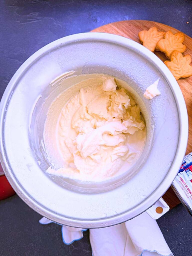 An ice cream maker filled with churned ice cream.