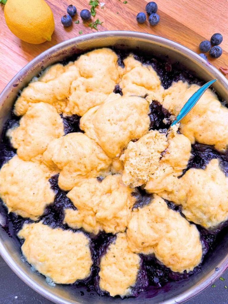 A steamed blueberry grunt in a metal pan.