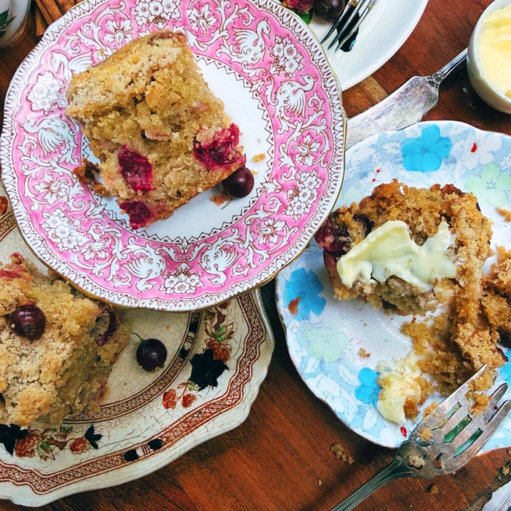 Three plates with slices of gooseberry coffee cake.