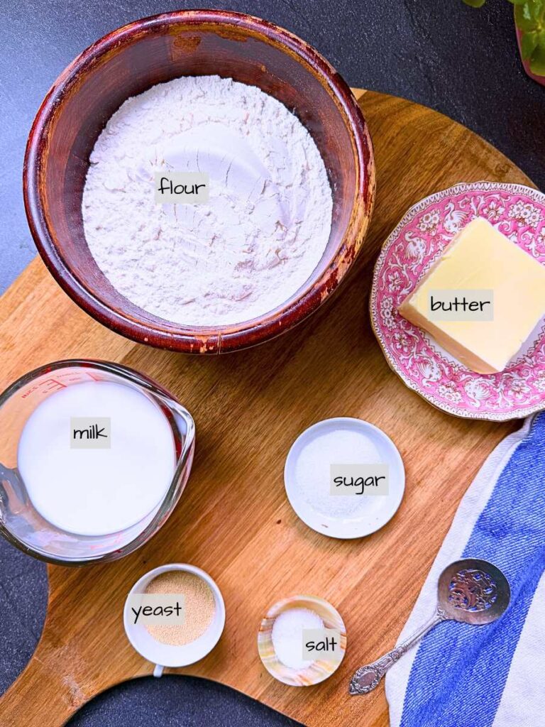 A collection of labeled ingredients on a wooden board.