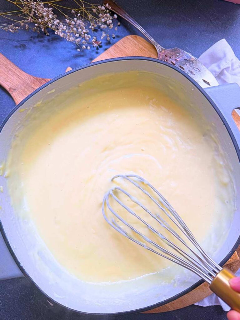 A vanilla custard in a large grey sauce pan.